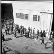 Group of people waving on dock (ddr-densho-426-278)