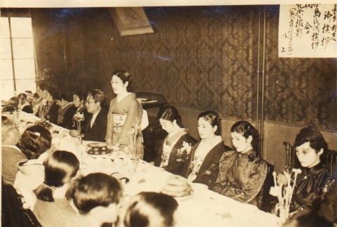 Woman speaking to others seated around a table (ddr-njpa-4-340)