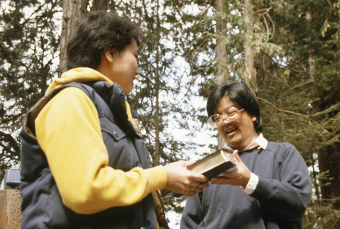 Marice Tatsuno presenting Eileen Yemoto with a Bible (ddr-densho-336-1756)