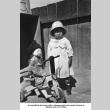 Girl with doll and tricycle (ddr-ajah-6-751)