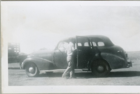 A man getting into a car (ddr-densho-300-117)