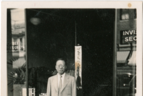 Man standing outside business (ddr-densho-426-2132)