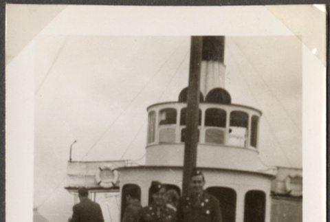 Two men standing by wheelhouse on ship (ddr-densho-466-77)
