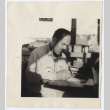 Man writing at a desk (ddr-densho-542-803)