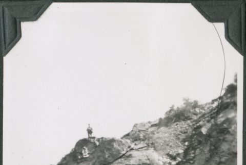 Man standing on hillside above tunnel (ddr-ajah-2-333)