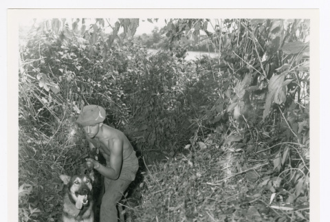 Private Russell P. Miszner and dog (ddr-densho-1007-101)
