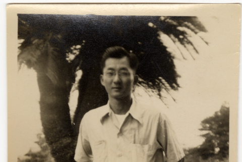 Man sitting on stone bench (ddr-densho-587-99)