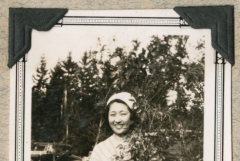Miriam Takatsuka behind tree branch (ddr-densho-383-238)