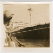 Man looking out over water toward ship (ddr-densho-426-1682)