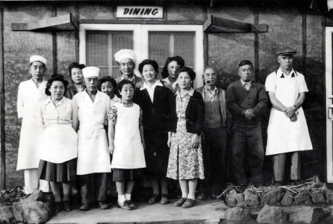 Group of workers in front of a dining hall at Tule Lake War Relocation Center (ddr-densho-474-218)