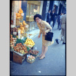 Martha (Nozawa) Tsuchida standing by fruit stand (ddr-densho-426-744)