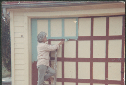 Agnes Sakura painting garage trim (ddr-densho-523-326)