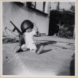 Susan Shiomi playing with toy gun (ddr-densho-522-271)