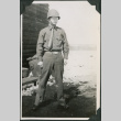 Man wearing helmet standing outside barracks (ddr-ajah-2-441)