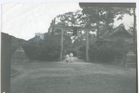 Shinto priests walk through temple entrance (ddr-densho-299-57)