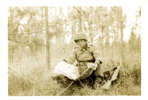 Soldier reading a newspaper (ddr-densho-22-207)