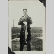 Man holding a steelhead trout (ddr-densho-201-322)
