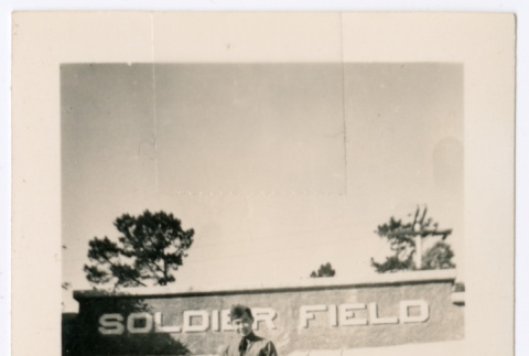 Man in front of Soldier Field sign (ddr-densho-368-523)
