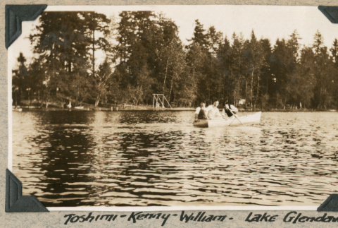 Three men in rowboat on lake (ddr-densho-383-181)
