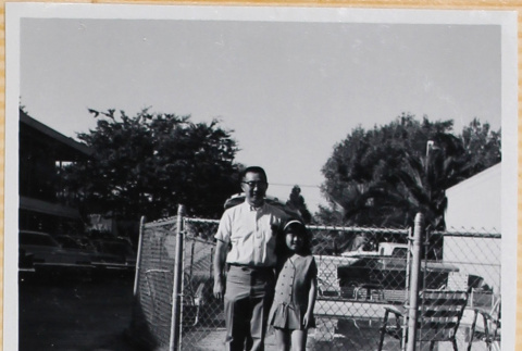 Man and girl standing by swimming pool (ddr-densho-522-122)