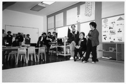 Woman speaking at Japanese Language School Reunion with two other alums (ddr-densho-506-96)
