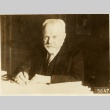 Marcel Regnier writing at his desk (ddr-njpa-1-1457)