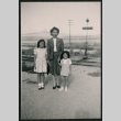 Japanese American woman and two girls pose near railroad crossing (ddr-densho-362-39)