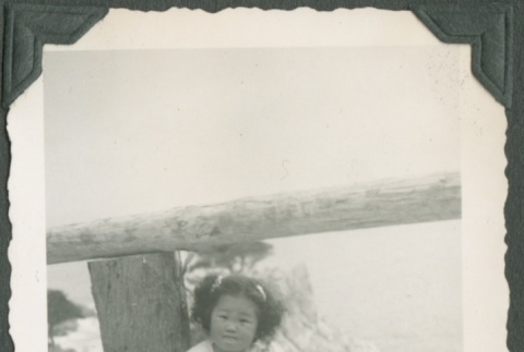 Carolyn Kawashima sitting on a fence (ddr-densho-328-181)