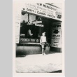 Tom Tadashi Nakayama in front of Broadmore cleaners (ddr-densho-353-243)