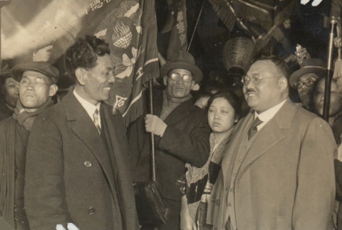 Man with a crowd holding flags (ddr-njpa-4-2405)