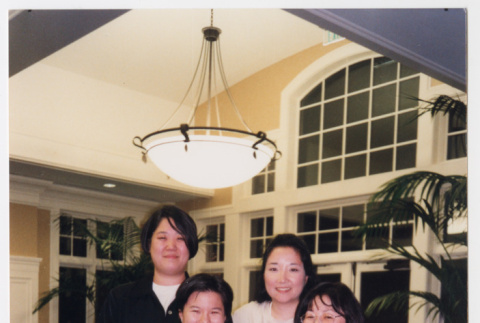 Photo of four Densho staff members with floral arrangment (ddr-densho-506-111)