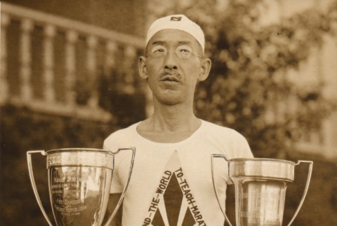 Man holding trophies (ddr-njpa-4-2327)