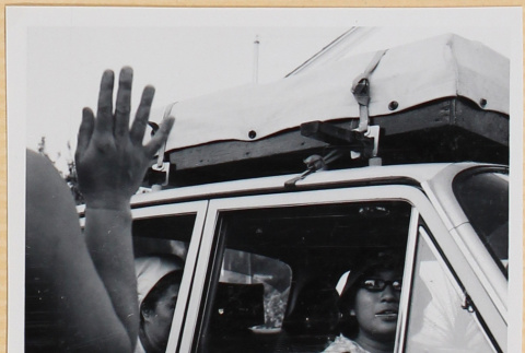 Woman waving to group in car (ddr-densho-522-102)