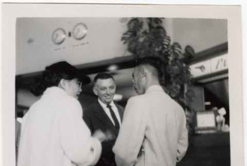Tomoye Takahashi standing with two men (ddr-densho-426-852)