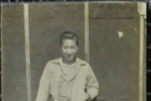 A young man in front of barracks (ddr-densho-321-1150)