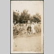 Woman and girl in garden, man in car in background (ddr-densho-293-45)
