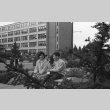Students on bench near Campion Hall, Seattle University campus (ddr-densho-354-2102)