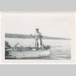 Man in boat with fish (ddr-densho-326-4)