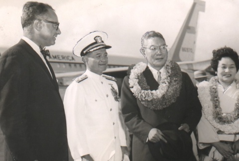 Hayato Ikeda and wife posing with captain and another man outside airplane (ddr-njpa-4-157)