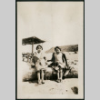 Two girls sitting on a log (ddr-densho-359-661)