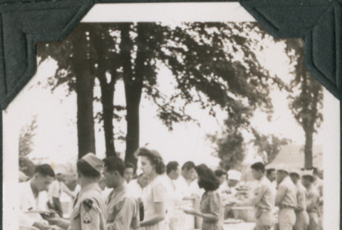 Group of men and women lined up at buffet table (ddr-ajah-2-528)