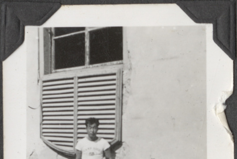 Man sitting on ledge by window (ddr-densho-466-676)