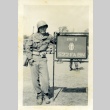 Soldier next to the 522nd Field Artillery Battalion sign (ddr-densho-22-335)