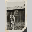 Woman holding young boy outside barracks (ddr-densho-466-923)
