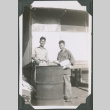 Two men standing by barrel.  Joe Iwataki on left (ddr-ajah-2-641)