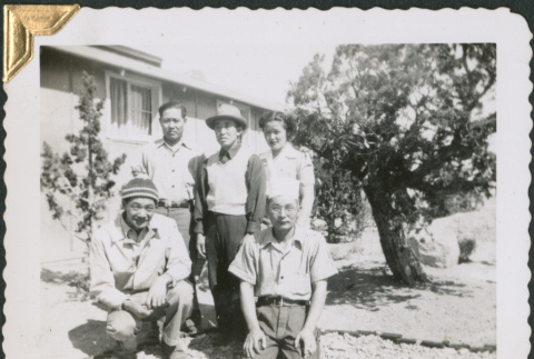 Four men and a woman standing outside barracks (ddr-densho-434-361)