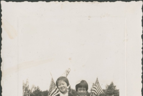 Two girls holding American flags (ddr-densho-321-818)