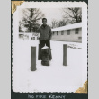 Man standing by fire hydrant with sign (ddr-densho-434-299)