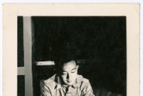 Bill Iino Sitting at Desk (ddr-densho-368-585)