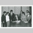 Signing of resolution seeking redress for Nisei who lost their jobs with the Seattle School District (ddr-densho-10-168)